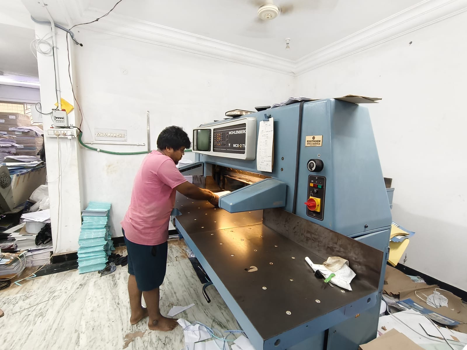 Operator using paper-cutting equipment at NSA Stationers